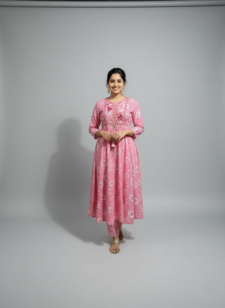 Woman wearing a pink traditional outfit on a gray background