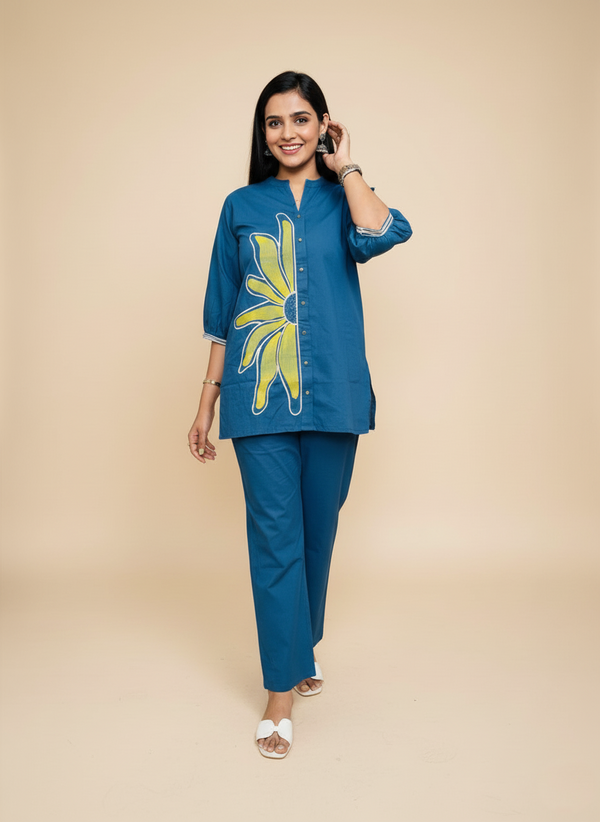 Woman wearing a blue outfit with a yellow floral design on a beige background