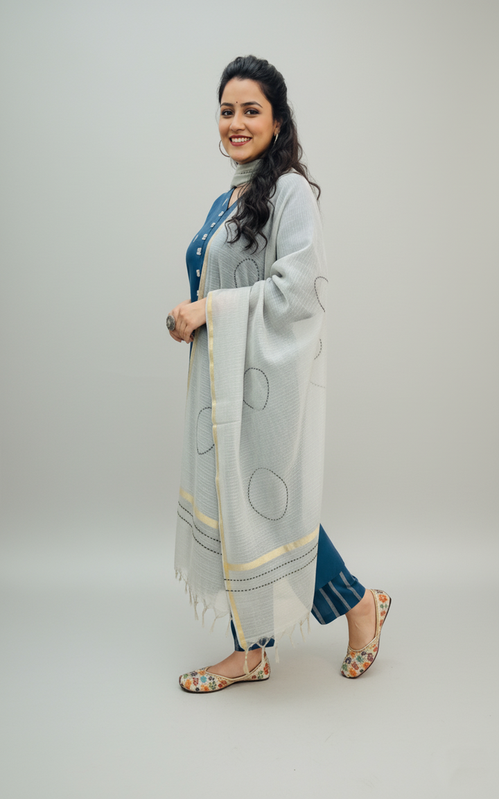 Woman wearing a light gray scarf with a white background