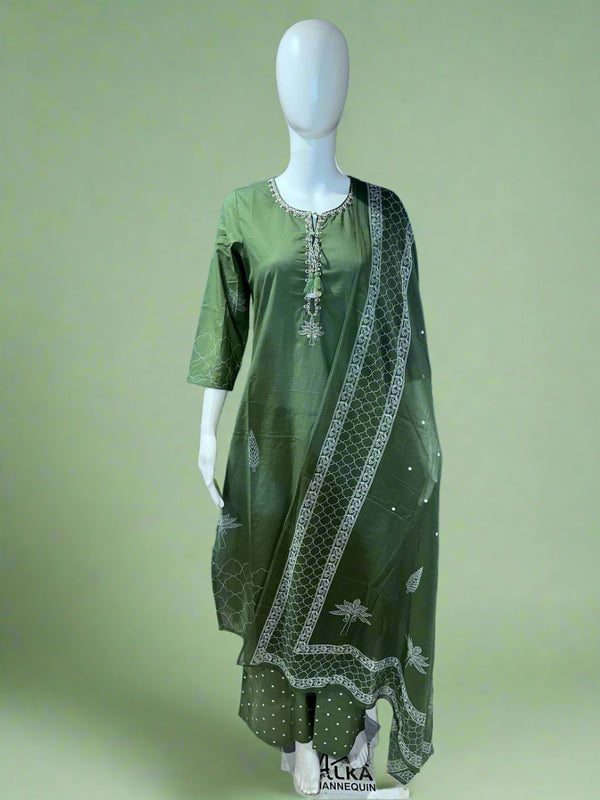Green traditional outfit with white patterns on a mannequin against a blue background with a logo.