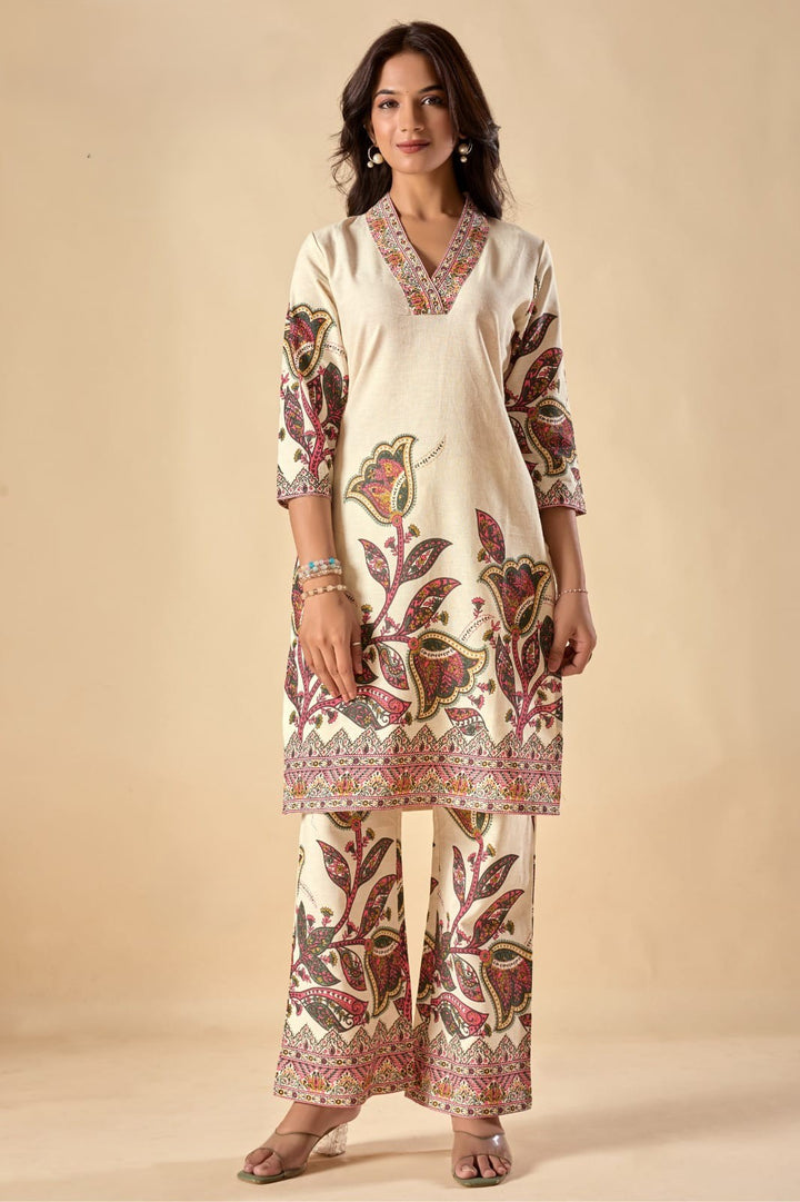 Woman wearing a cream-colored kurta with floral patterns on a beige background