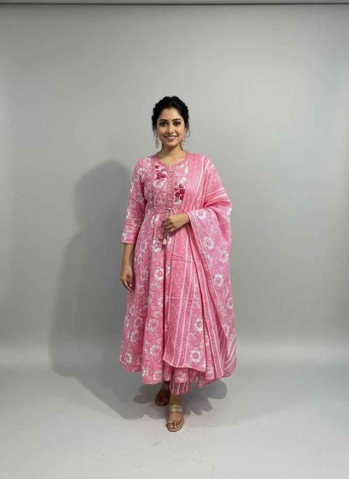 Woman wearing a pink traditional outfit with a white background