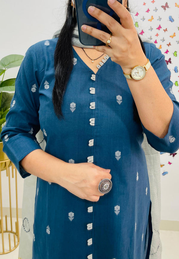 A person wearing a blue dress with white patterns,